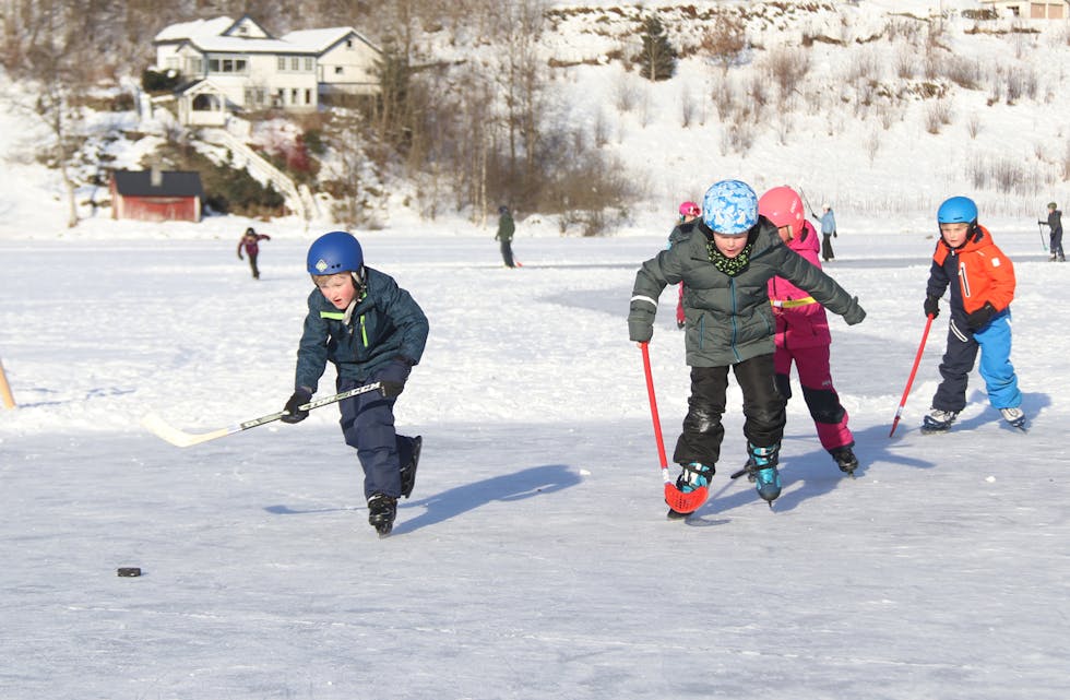 Ved hjelp av snøskuffer og vatn blei hockeybanane fullt brukelege. Her er det elevar frå andre klasse på Risvoll skule som kosar seg.
