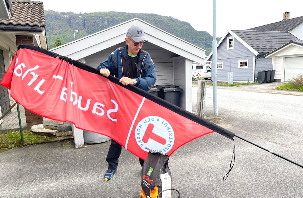 Bjarne Bertelsen er klar med banner, grillkol og kaffikanne for å reklamera for sin store hobby: Sauda turlag. 